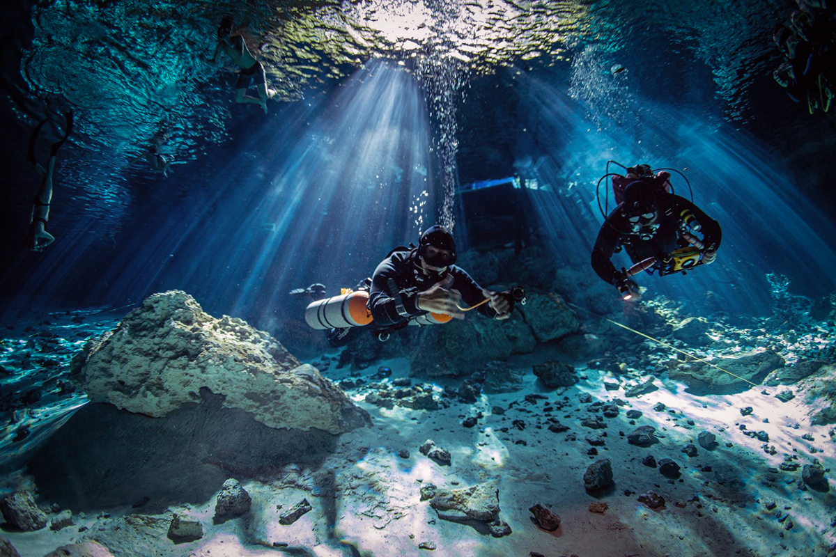 Dive guides enter the cenote