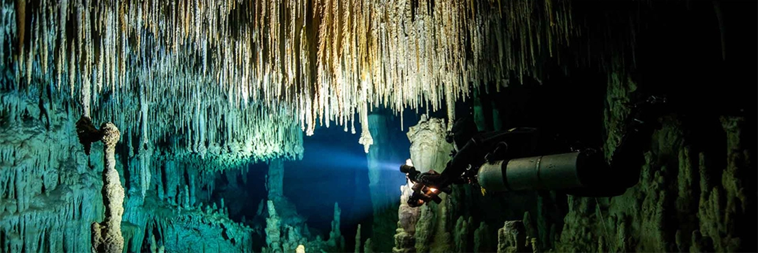 Cenote diver swims towards the exit