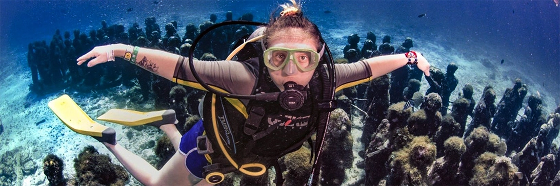 Diver flies over the Salon Manchones scupltures