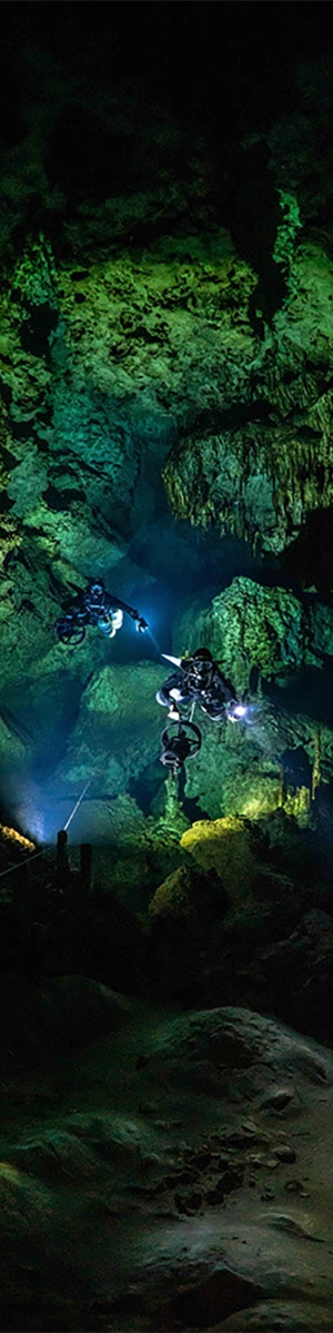Divers pose for a photo in a large cave