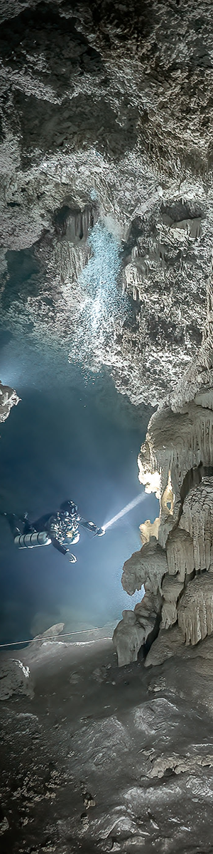 Diver admiring speleothems inside the caverns