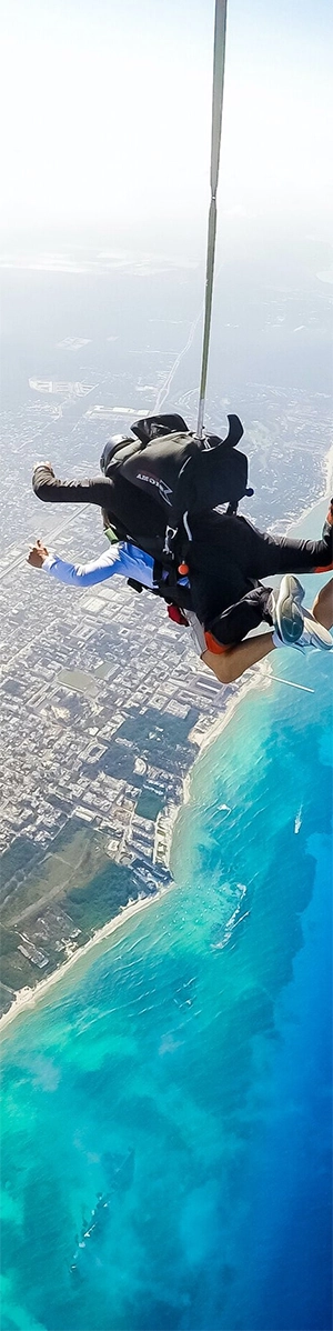 Tandem skydivers over Playa del Carmen