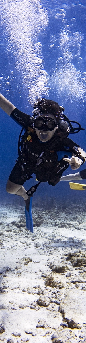 Scuba diving student takes out his regulator and pulls his tongue at the camera