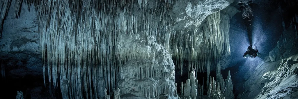 Diver exploring underwater crypt