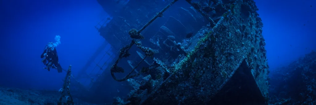 Diver floats next to a wreck