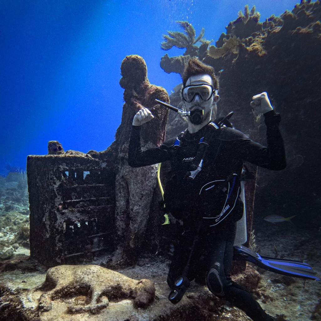 PADI Scuba Diver shows his muscles with the Dreamcatcher