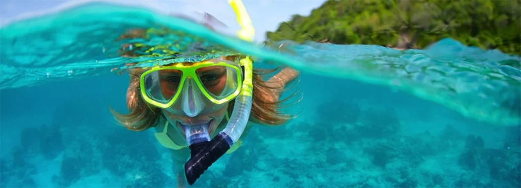 Snorkeler floats above the waves