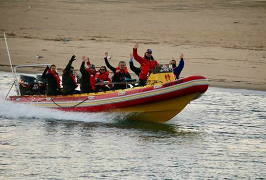 Divers wave from boat