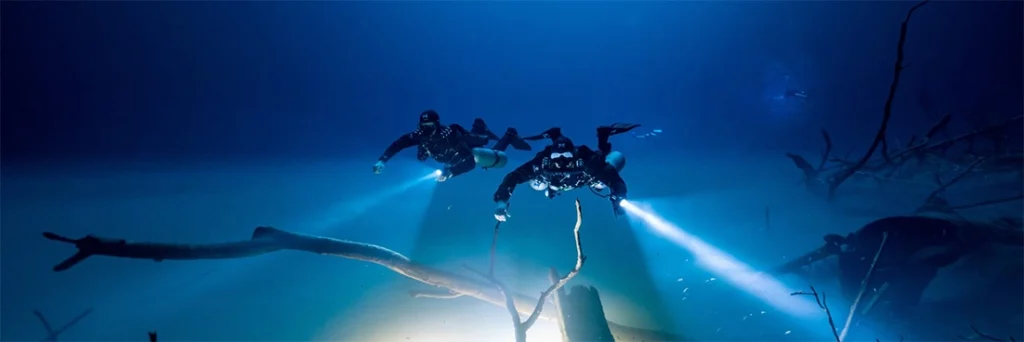 Divers float above Cenote Angelita's hydrogen sulphur cloud